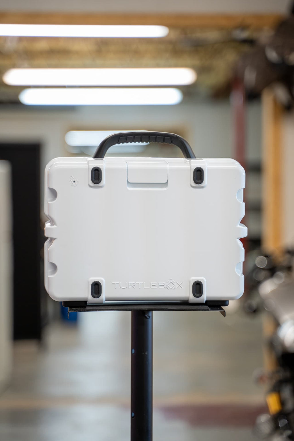 lifestyle photo showing the gray rubber feet on the back of a white Turtlebox  #feet-color_gray