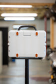 Lifestyle photo showing the burnt orange rubber feet on the back of a white Turtlebox  lifestyle #feet-color_burnt-orange
