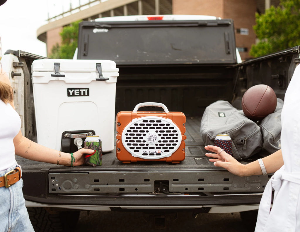A lifestyle photo of a Burnt Orange & White Original Gen 3 speaker. #speaker-color_burnt-orange-white-gameday-series