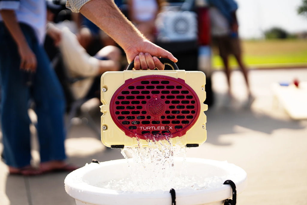 A lifestyle photo of a Gold & Garnet Original Gen 3 speaker. #speaker-color_gold-garnet-gameday-series