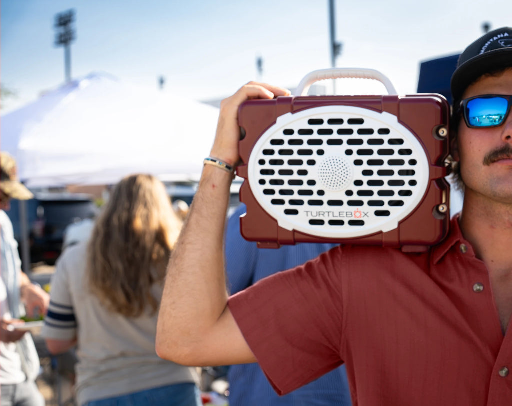 A lifestyle photo of a Maroon & White Original Gen 3 speaker. #speaker-color_maroon-white-gameday-series