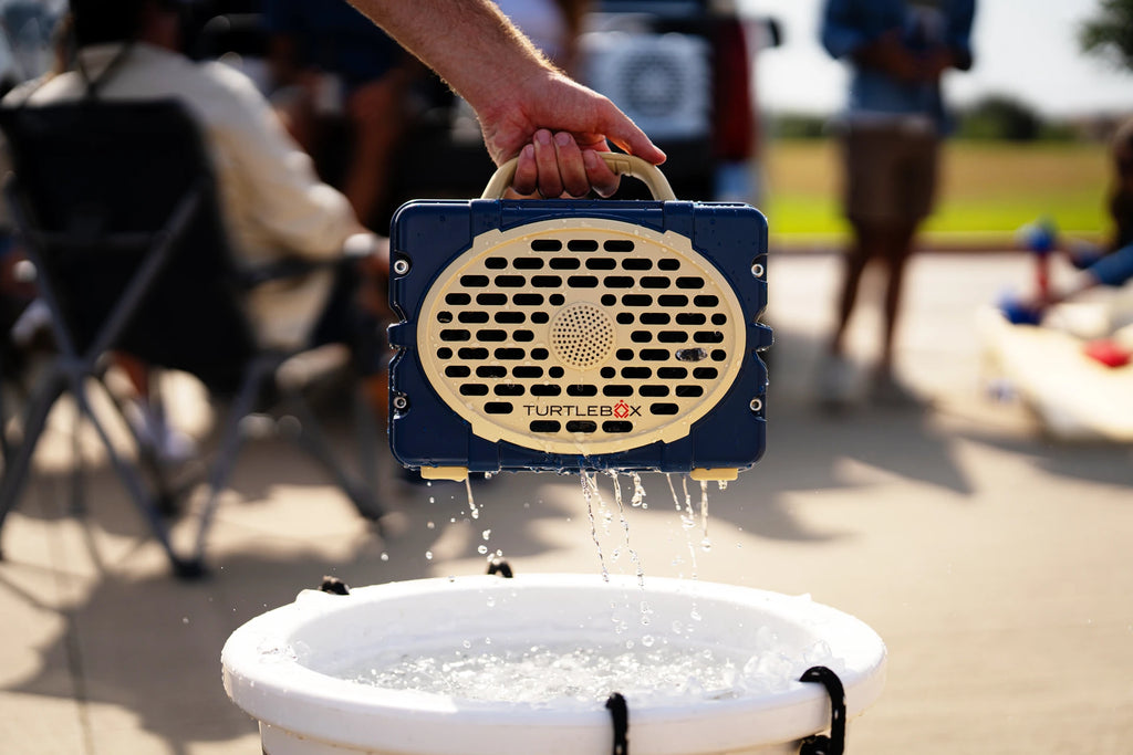 A lifestyle photo of a Navy & Gold Original Gen 3 speaker. #speaker-color_navy-gold-gameday-series