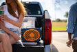 A lifestyle photo of a Navy & Orange Original Gen 3 speaker. #speaker-color_navy-orange-gameday-series