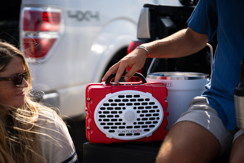 A lifestyle photo of a Red & White Original Gen 3 speaker. #speaker-color_red-white-gameday-series