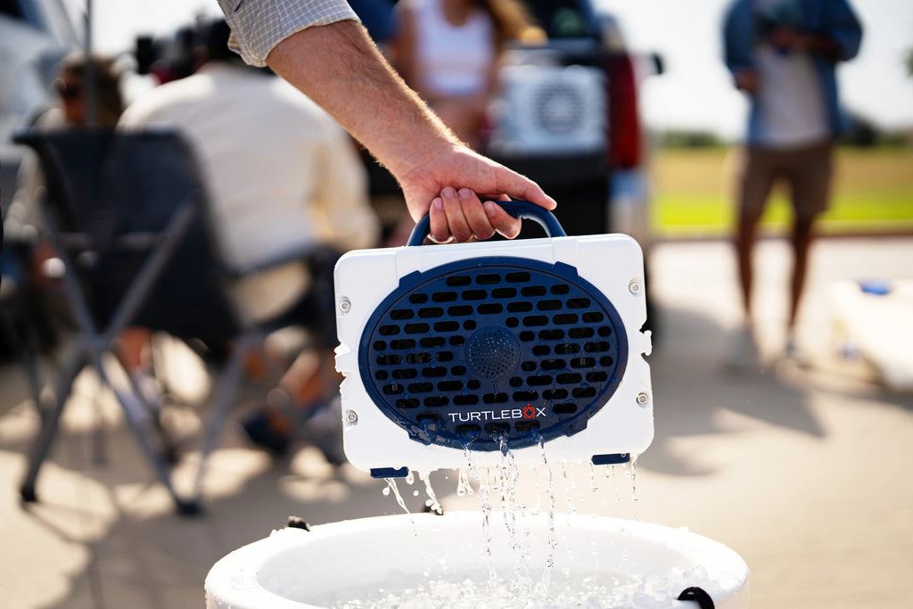 A lifestyle photo of a White & Navy Original Gen 3 speaker. #speaker-color_white-navy-gameday-series
