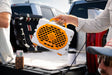 A lifestyle photo of a White & Orange Original Gen 3 speaker. #speaker-color_white-orange-gameday-series