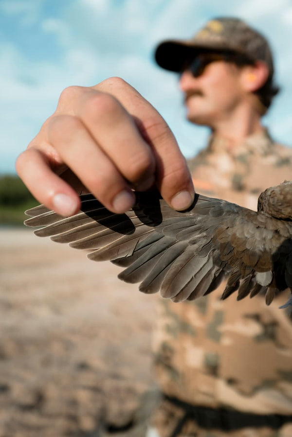 A guy holding a bird in his hands