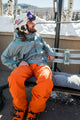 A lifestyle photo of a free skier sitted on a bench with a Ranger speaker in River Rock attached to it. #base-color_river-rock