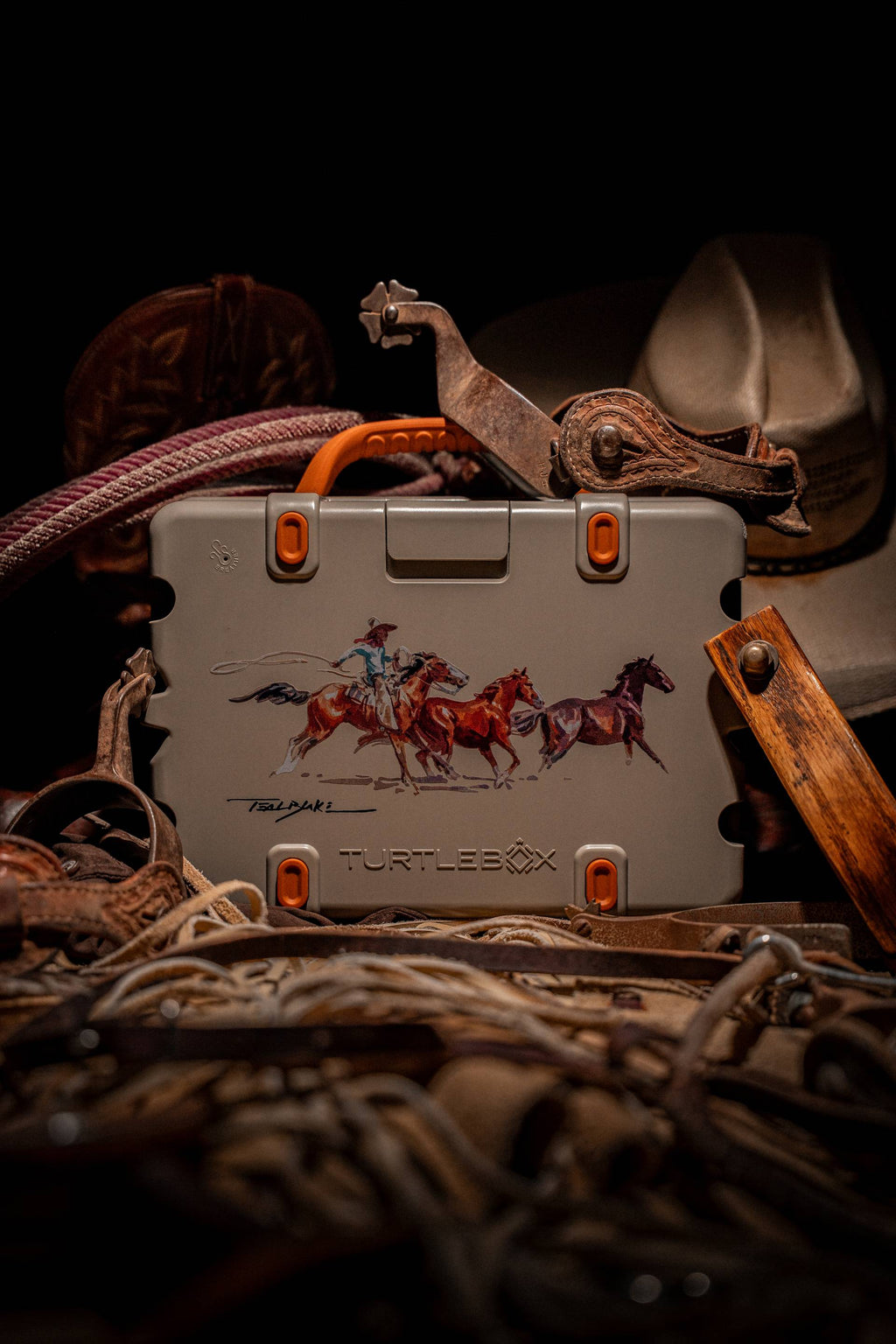 A lifestyle image of Original Gen 3 speaker showing the Western variant, a tan burnt orange speaker with a Rodeo paint from Teal Blake artist