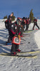 Group of skiers preparing on a snowy slope with clear blue sky
