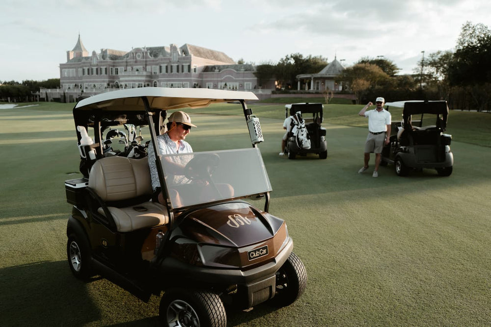 A golf car with a Turtlebox Ranger speaker attached to the metallic structure by its magnets