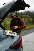 A lifestyle photo of a Ranger Ivory speaker mounted on the side of a car #base-color_ivory