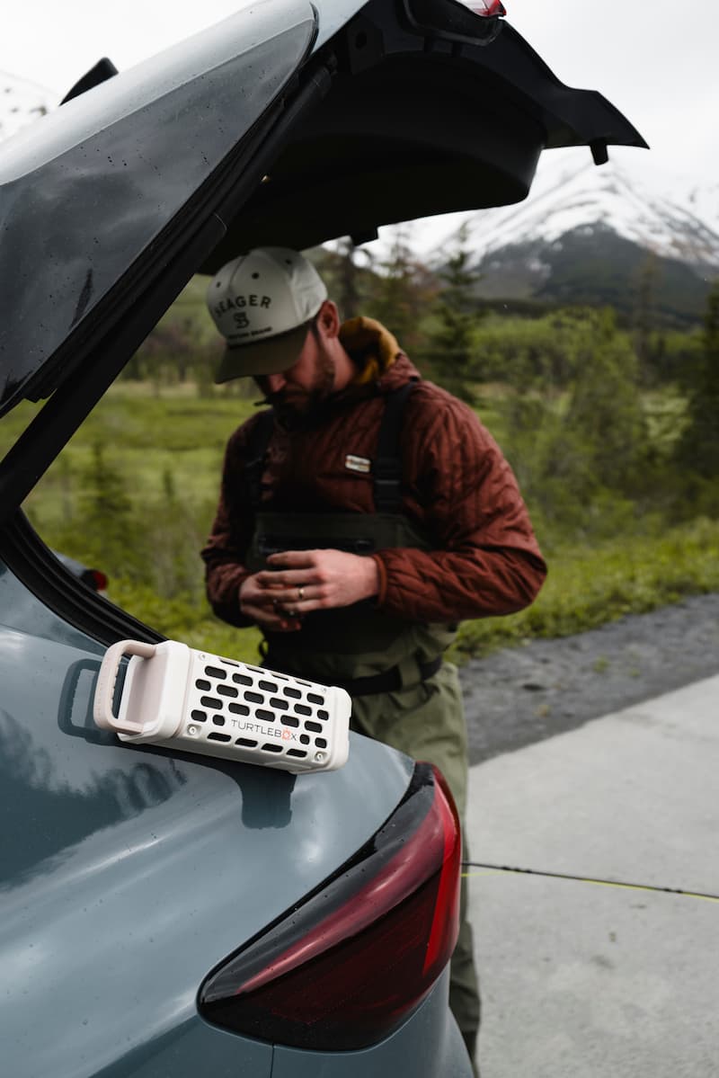 A lifestyle photo of a Ranger Ivory speaker mounted on the side of a car #base-color_ivory