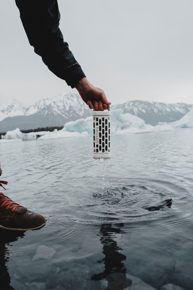 A lifestyle photo showing a Ranger Ivory  dripping water after being submerged, with a snowy background #base-color_ivory