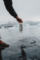 A lifestyle photo showing a Ranger Ivory  dripping water after being submerged, with a snowy background #base-color_ivory